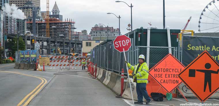 construction worker
							standing with stop sign in Seattle